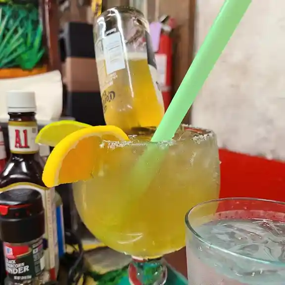Assorted margaritas garnished with orange and lemon slices